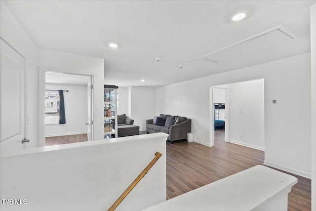 living room featuring attic access, baseboards, dark wood finished floors, and recessed lighting