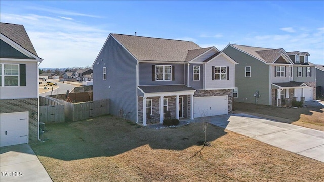 traditional home featuring driveway, a front lawn, fence, and a residential view