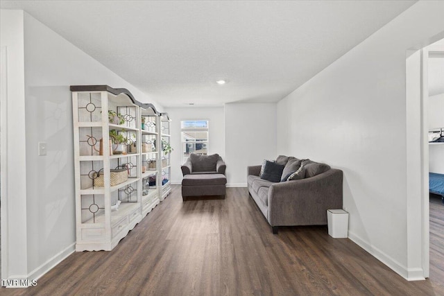 living area with dark wood finished floors and baseboards