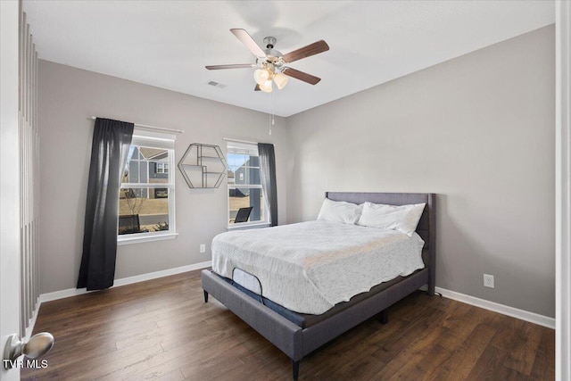 bedroom with a ceiling fan, baseboards, visible vents, and dark wood-style flooring