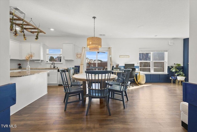 dining room featuring a textured ceiling, dark wood-style flooring, and recessed lighting