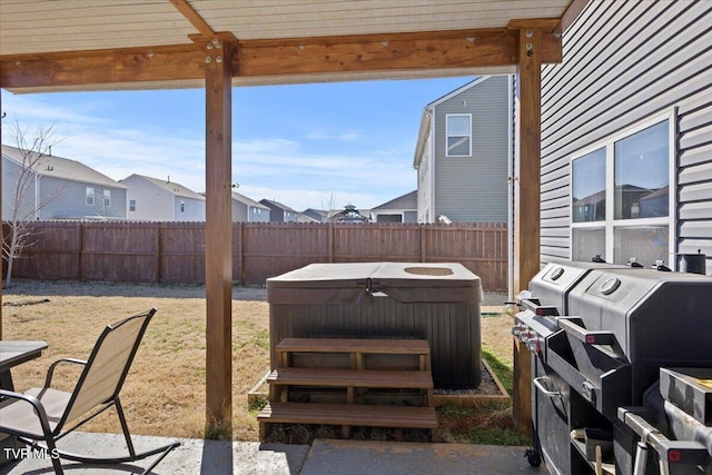 view of yard featuring fence, a residential view, and a hot tub