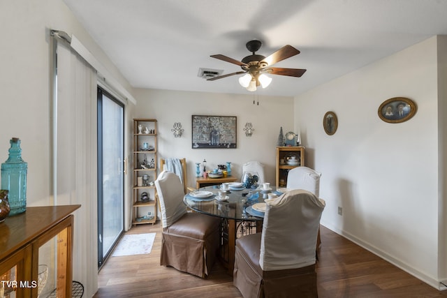 dining area with ceiling fan, wood finished floors, visible vents, and baseboards