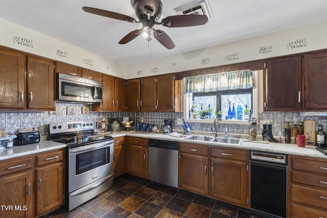 kitchen featuring light countertops, appliances with stainless steel finishes, a sink, and decorative backsplash