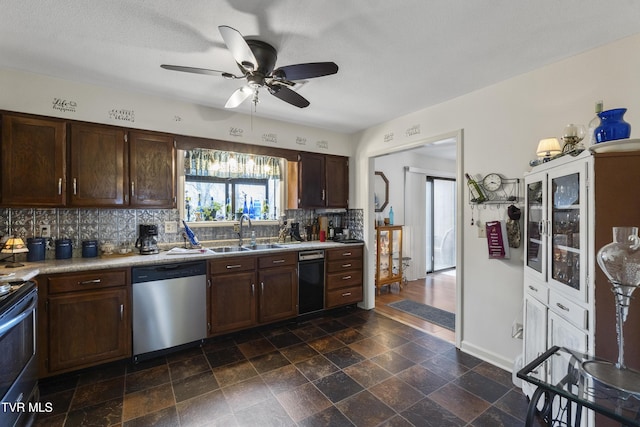 kitchen featuring light countertops, decorative backsplash, appliances with stainless steel finishes, a sink, and dark brown cabinets