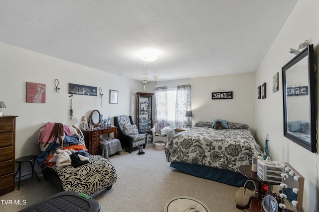 bedroom featuring a textured ceiling and carpet flooring