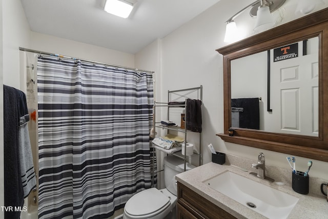 bathroom with toilet, a shower with shower curtain, and vanity