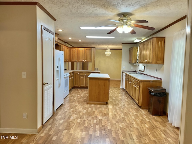 kitchen featuring crown molding, light wood-type flooring, white appliances, and a kitchen island