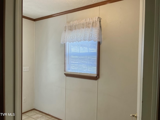 empty room featuring crown molding