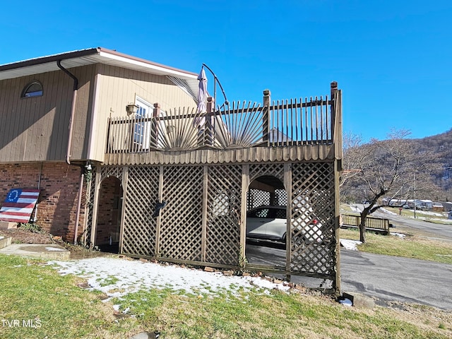 view of home's exterior featuring a deck and brick siding