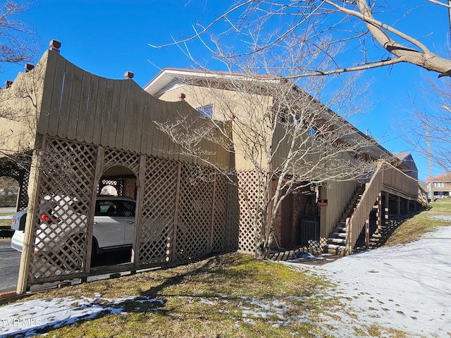 view of snow covered exterior featuring stairway