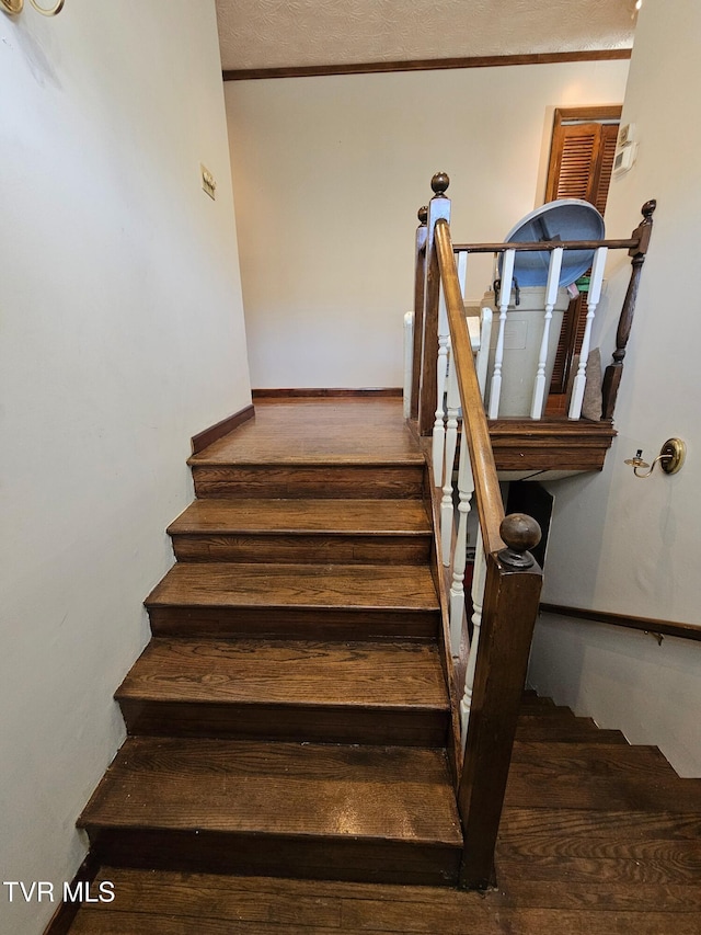 stairs featuring wood finished floors