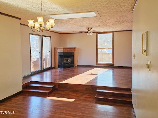 unfurnished living room with crown molding, a fireplace, and dark wood finished floors