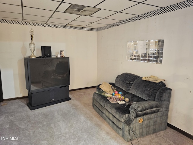 carpeted living area with baseboards, visible vents, and a drop ceiling