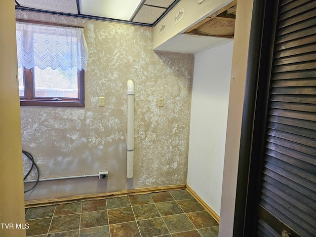 laundry room featuring baseboards and wallpapered walls