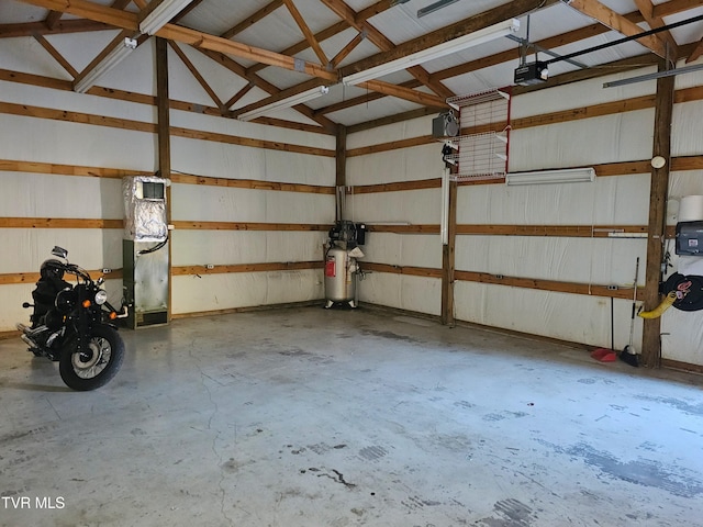 garage with a garage door opener and metal wall