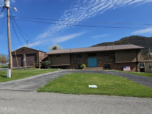 316 W Shawnee Ave, Big Stone Gap, VA 24219 - view of front of property with brick siding, a front lawn, aphalt driveway, and metal roof