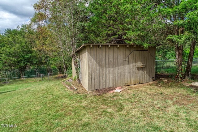 view of shed featuring fence