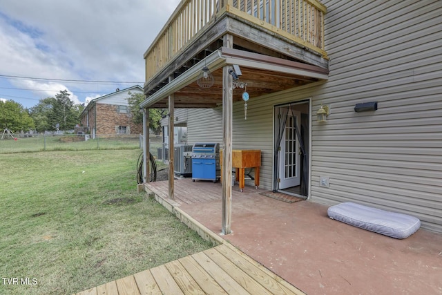 wooden deck with a yard, grilling area, and fence