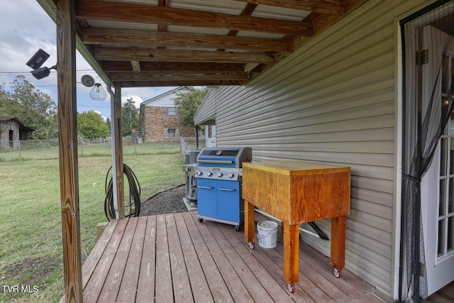 wooden deck featuring a yard, fence, and area for grilling