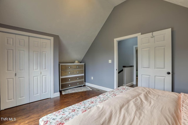 bedroom featuring lofted ceiling, dark wood finished floors, and baseboards