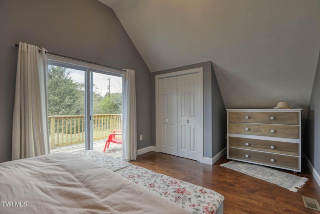 bedroom with visible vents, baseboards, lofted ceiling, dark wood-style floors, and access to exterior