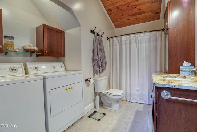 bathroom featuring toilet, washer and clothes dryer, lofted ceiling, and vanity