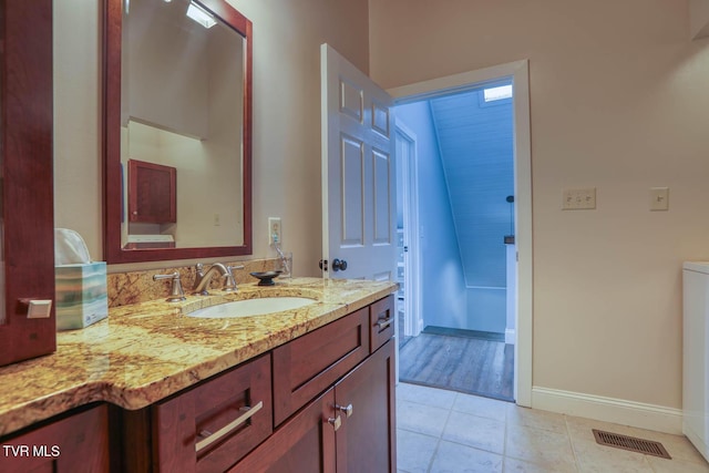 bathroom with tile patterned flooring, visible vents, vanity, and baseboards