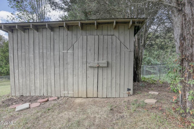 view of shed featuring fence