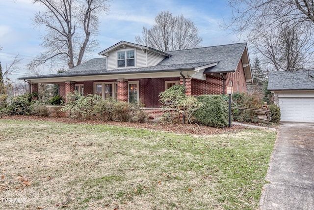 bungalow-style house featuring roof with shingles, a front yard, and brick siding