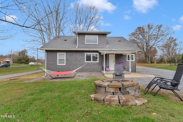 back of property featuring a lawn