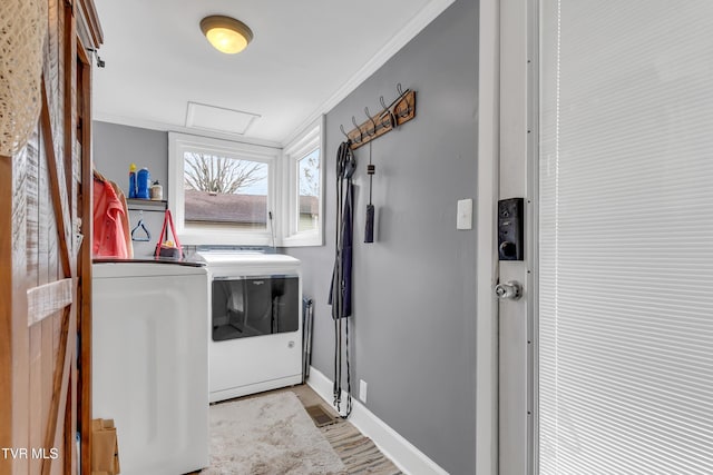 laundry room featuring laundry area, baseboards, washer and dryer, ornamental molding, and attic access