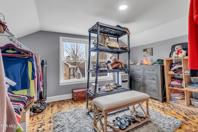 bedroom with vaulted ceiling, recessed lighting, wood finished floors, and baseboards