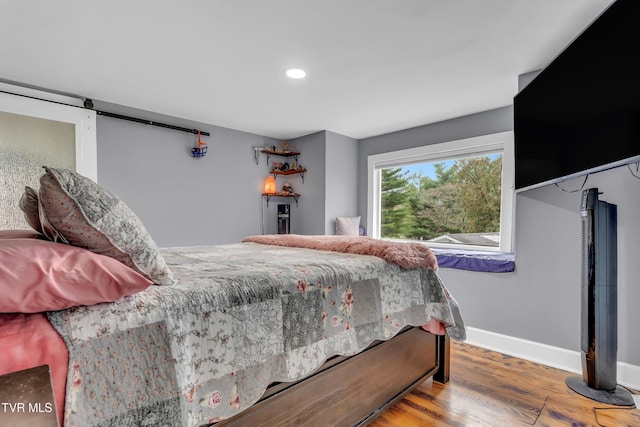 bedroom featuring recessed lighting, wood finished floors, and baseboards