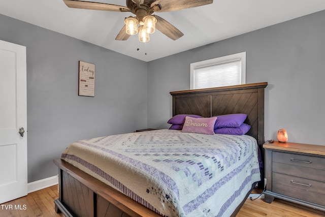 bedroom featuring light wood-type flooring, ceiling fan, and baseboards