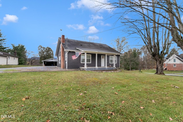 bungalow-style house featuring a front yard, covered porch, and a chimney