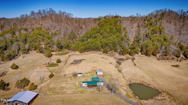 birds eye view of property with a view of trees