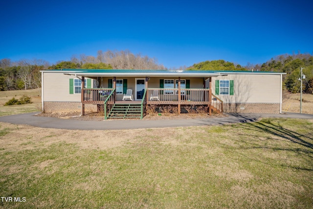 view of front of home with a porch and a front lawn