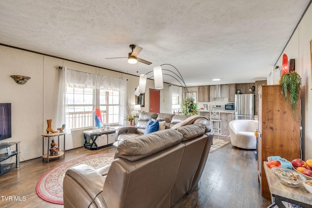 living room featuring a textured ceiling, a ceiling fan, and dark wood-style flooring