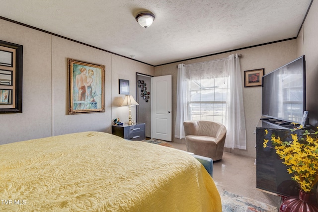 bedroom featuring crown molding and a textured ceiling