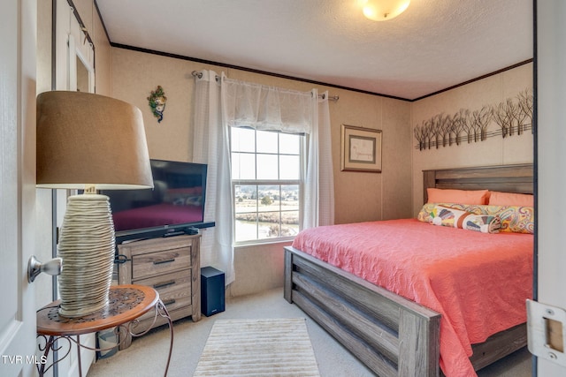 carpeted bedroom featuring ornamental molding and a textured ceiling