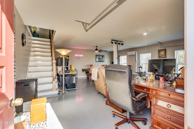 office featuring speckled floor, ceiling fan, and a wall mounted AC