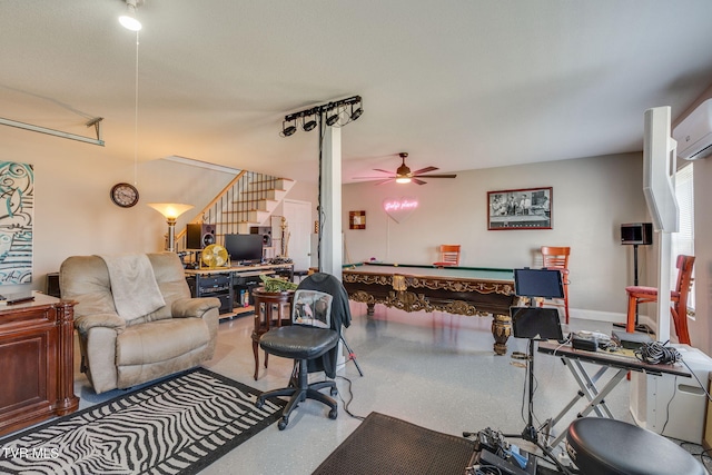 interior space with a ceiling fan, an AC wall unit, pool table, and speckled floor