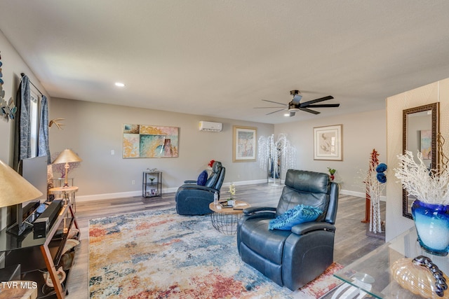 living room with ceiling fan, recessed lighting, wood finished floors, baseboards, and a wall mounted AC