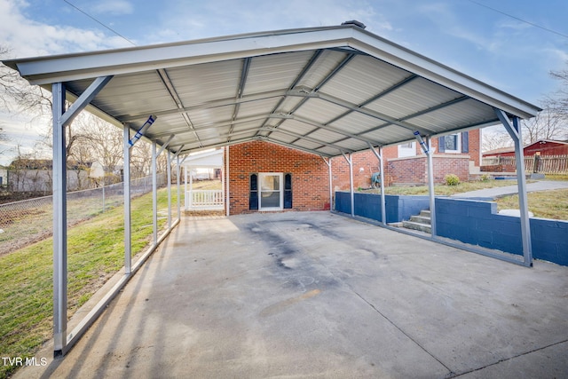 view of car parking with a carport and fence