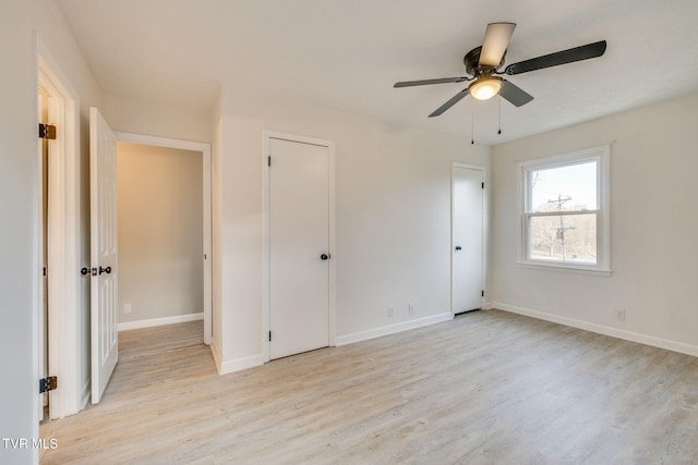 unfurnished bedroom with baseboards, a ceiling fan, and light wood-style floors