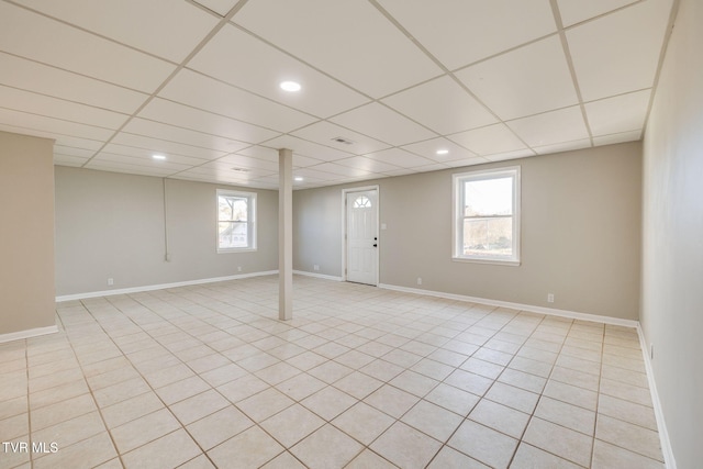 below grade area with a paneled ceiling, visible vents, baseboards, and recessed lighting