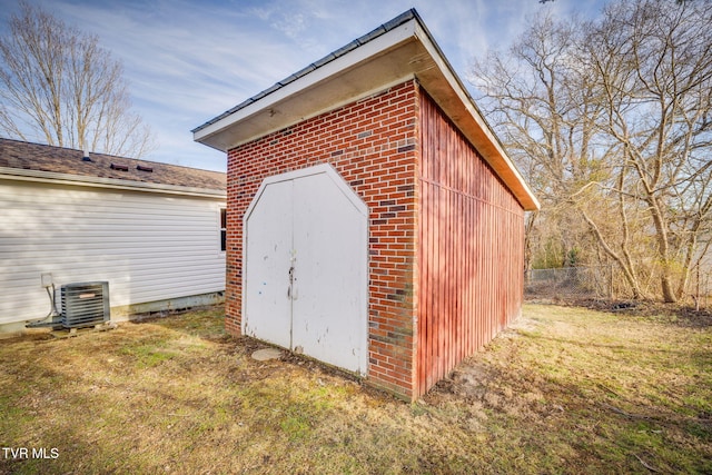 view of shed featuring cooling unit and fence