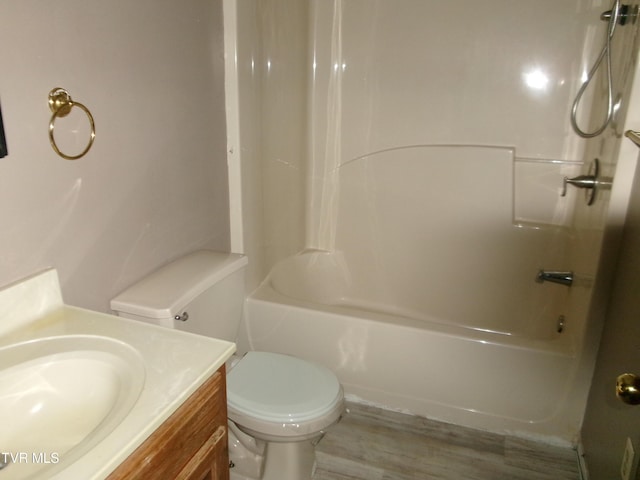 full bathroom with shower / bathing tub combination, vanity, toilet, and wood finished floors