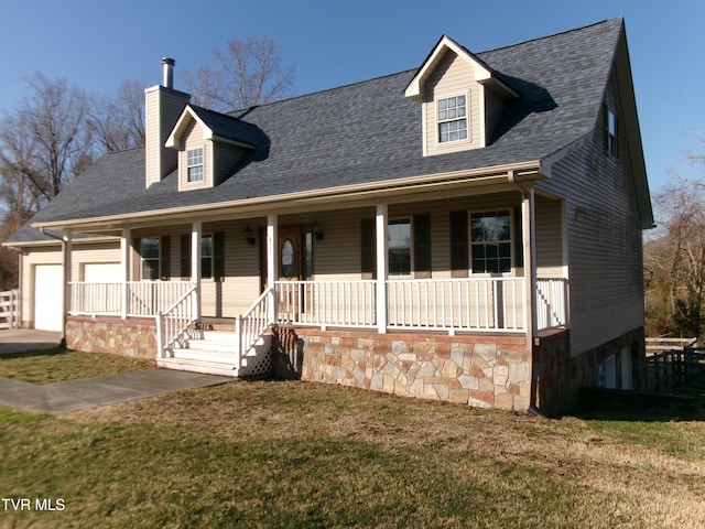 view of front facade with a garage, a porch, a front lawn, and a chimney